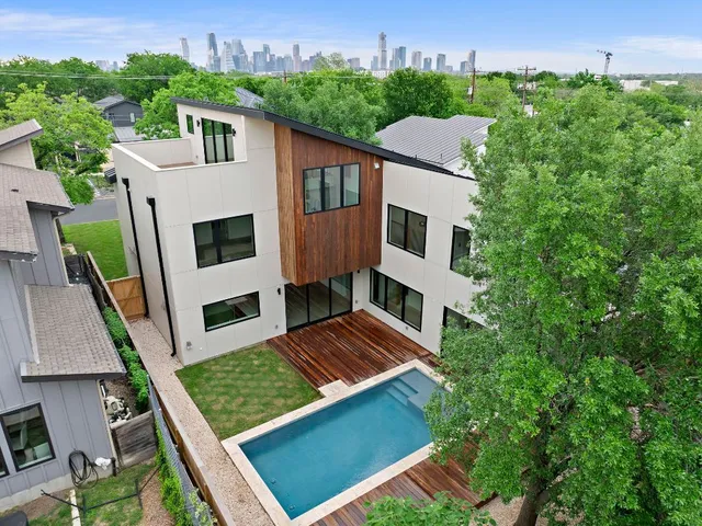 an aerial view of multiple houses with a yard