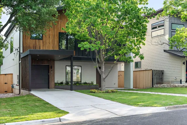 a front view of house with a garden