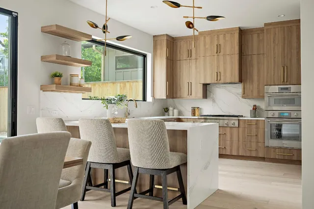 a kitchen with a table chairs microwave and cabinets