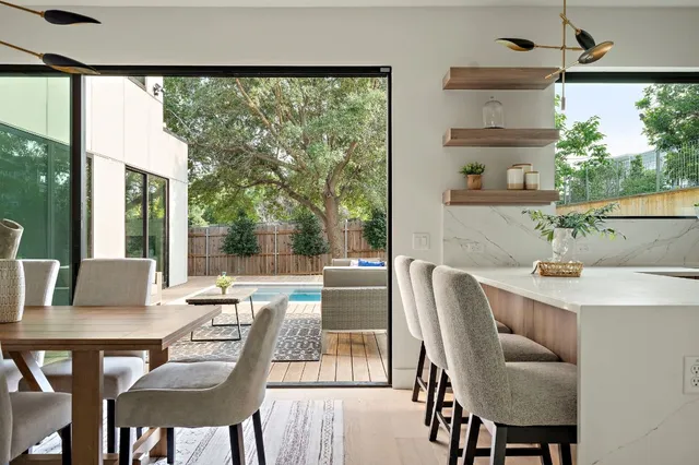 a dining room with furniture and a large window