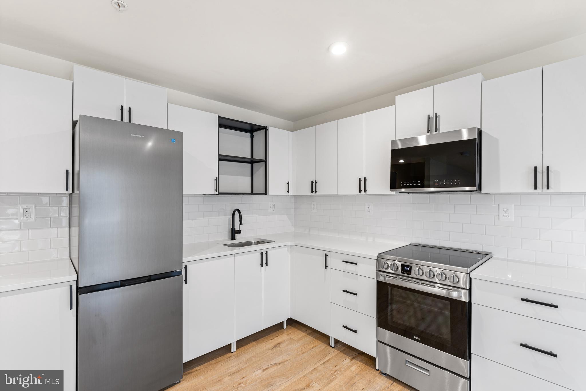 2395 Terrapin Crossing Jessup, MD 20794 - Photo 3 of 11 a kitchen with stainless steel appliances a refrigerator stove and microwave