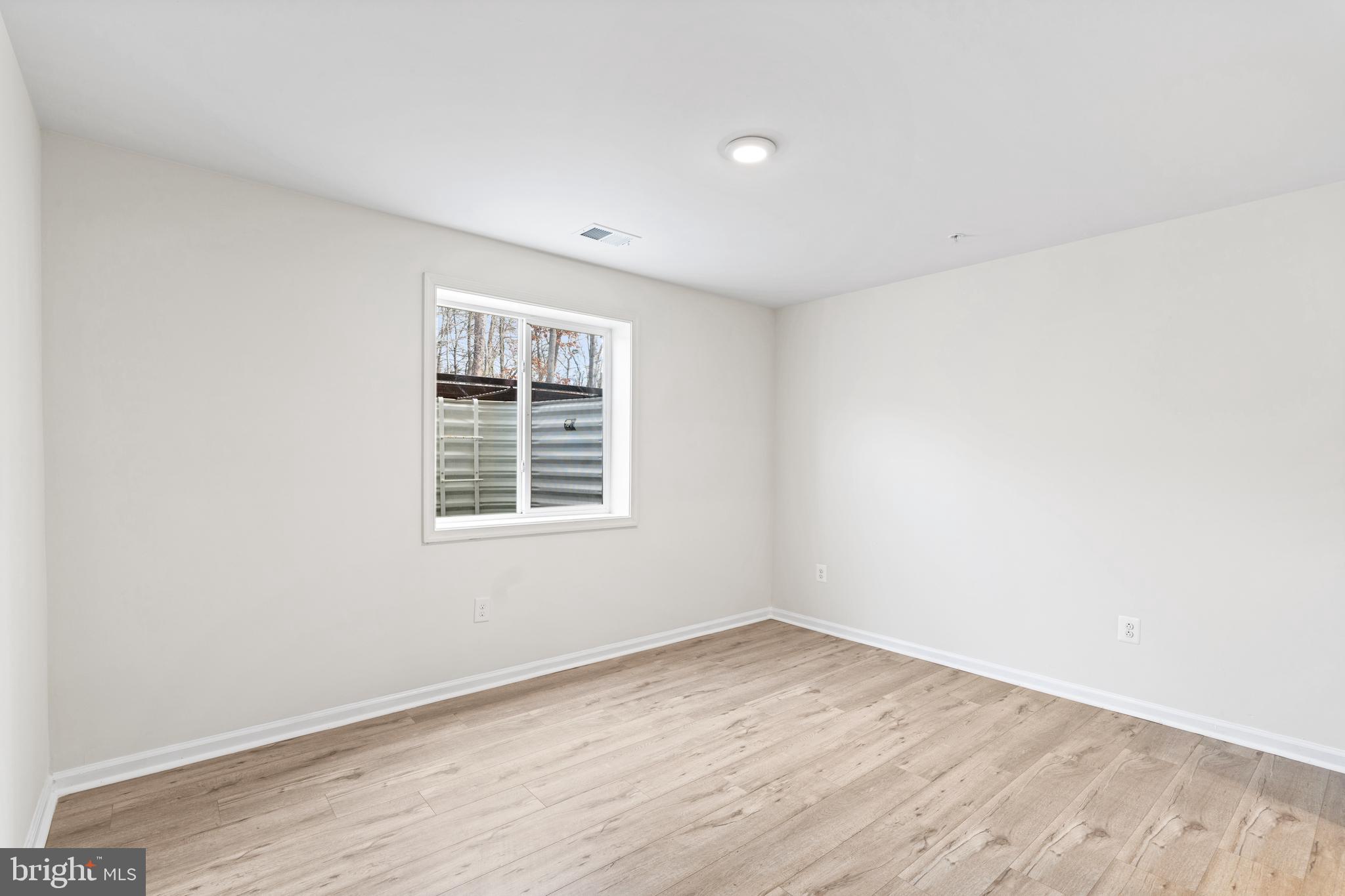2395 Terrapin Crossing Jessup, MD 20794 - Photo 4 of 11 an empty room with wooden floor and windows