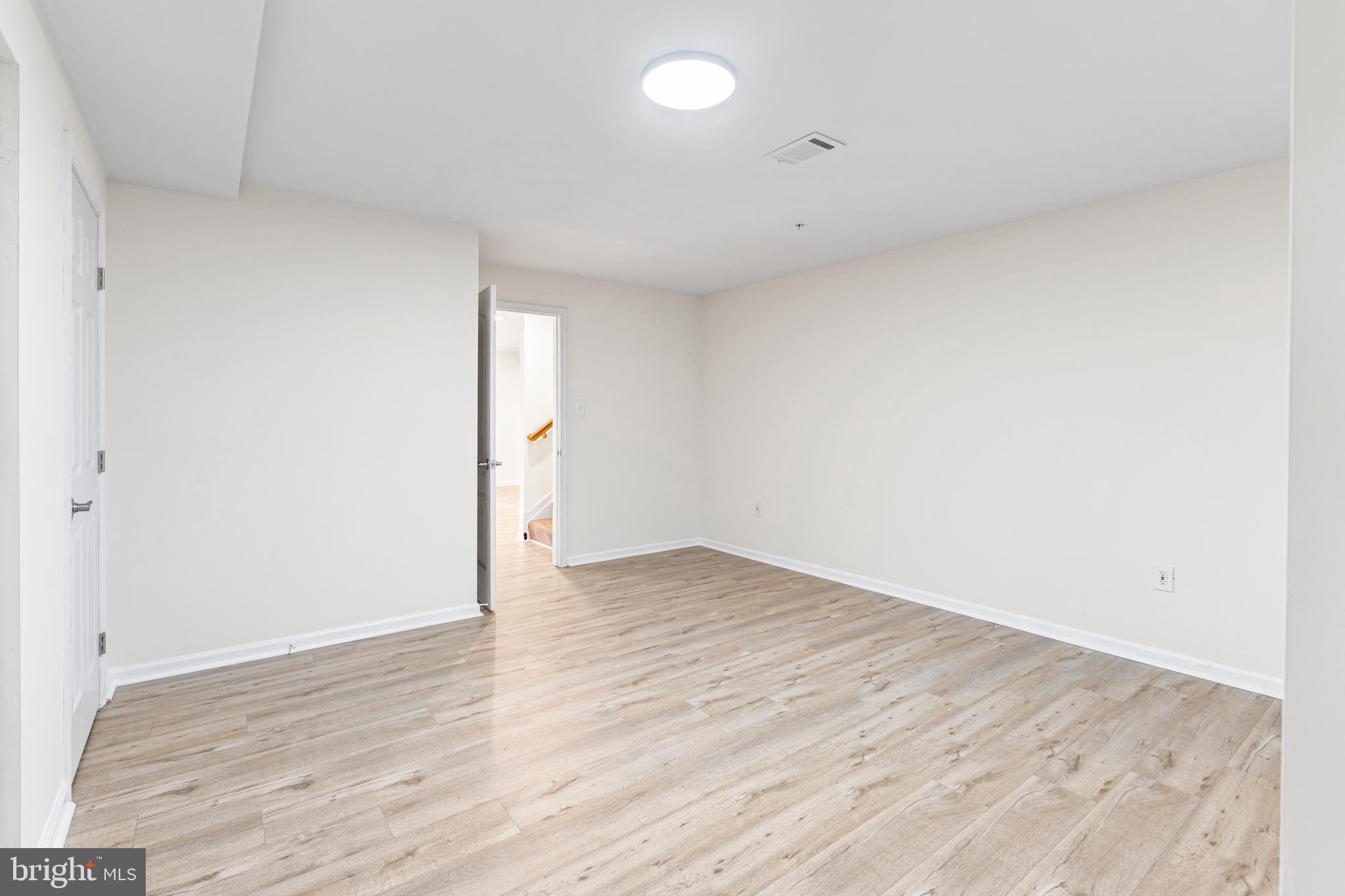 2395 Terrapin Crossing Jessup, MD 20794 - Photo 9 of 11 an empty room with wooden floor and windows