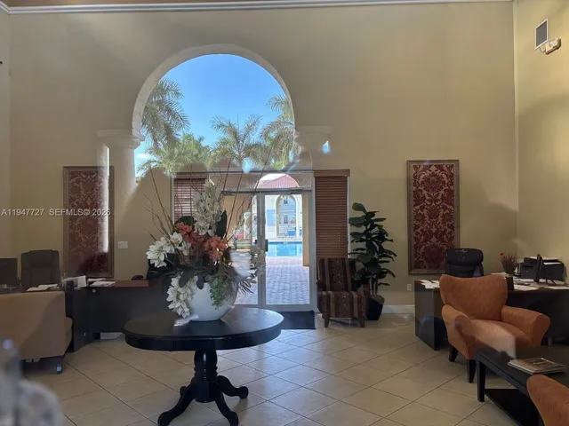 a lobby with furniture and potted plants