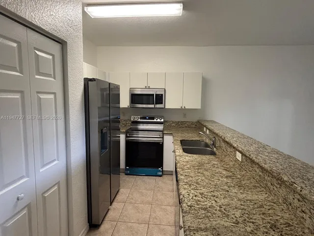 a kitchen with a refrigerator stove and microwave