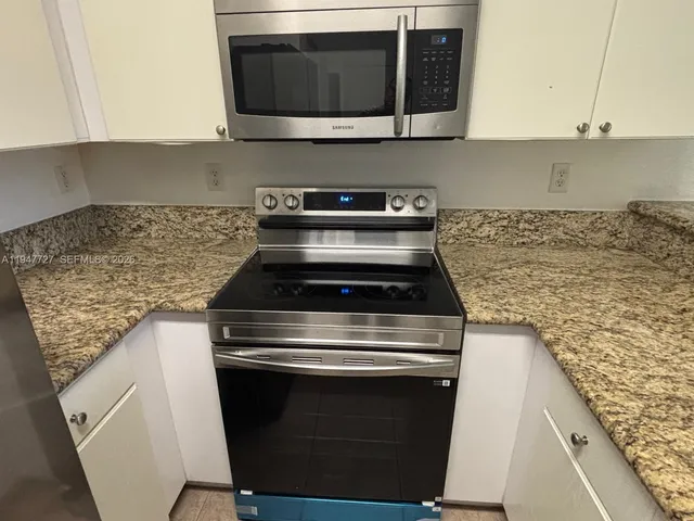 a stove top oven sitting inside of a kitchen