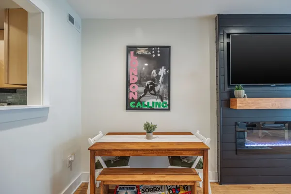 a room with a table and a painting on the wall