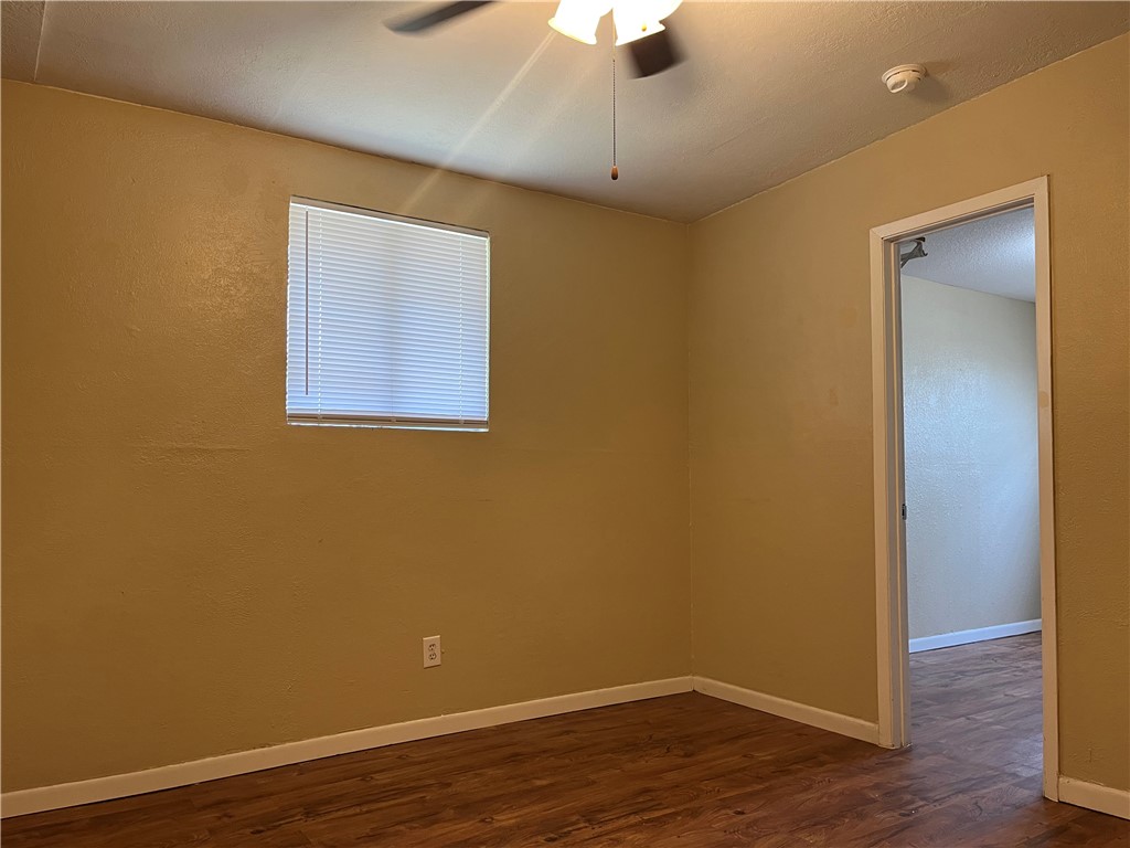 138 Doyle Drive Portland, TX 78374 - Photo 17 of 24 a view of an empty room with wooden floor and a ceiling fan
