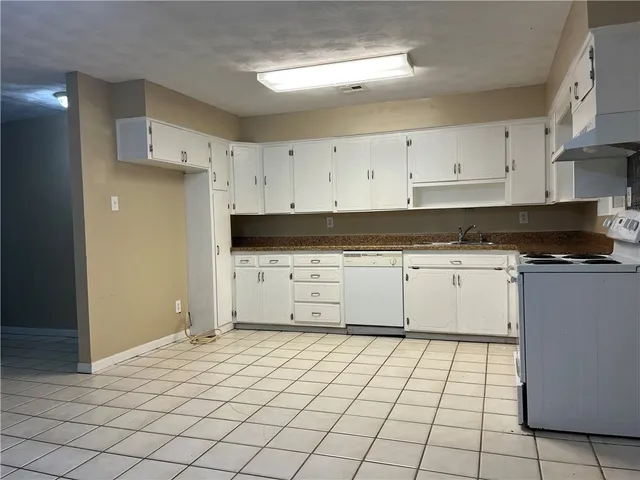 a kitchen with stainless steel appliances a sink and cabinets