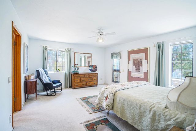 a bedroom with a bed chair and window