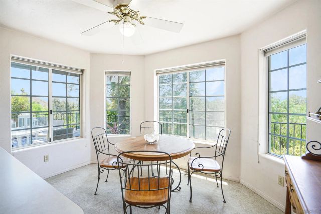 a dining room with furniture a chandelier and wooden floor