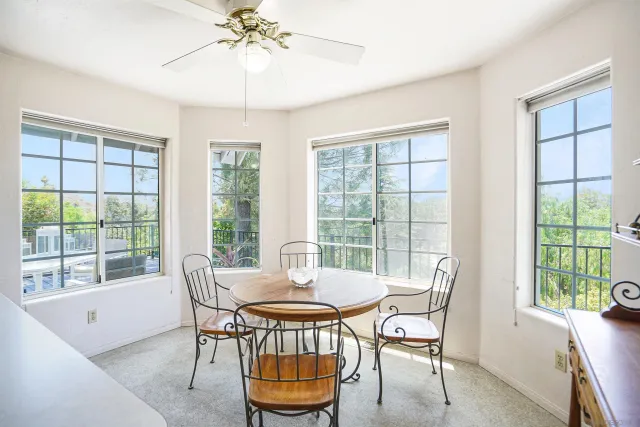 a dining room with furniture a chandelier and wooden floor