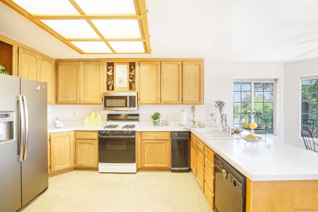 a kitchen with a sink stove and refrigerator
