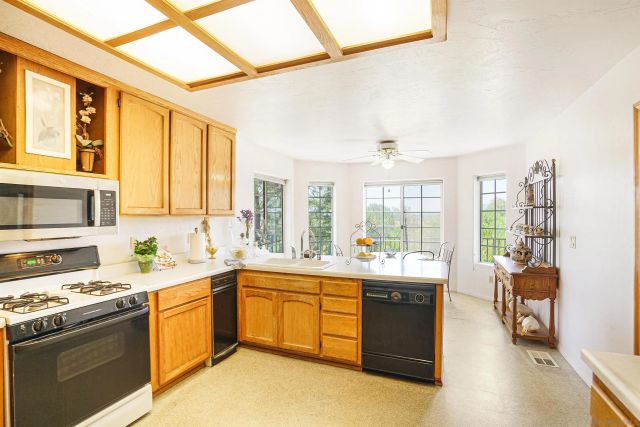 a kitchen with a sink stove and cabinets