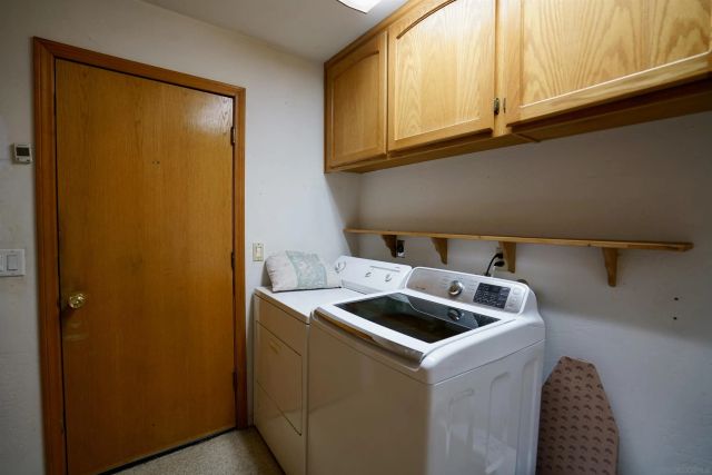 a kitchen with a sink a refrigerator and cabinets