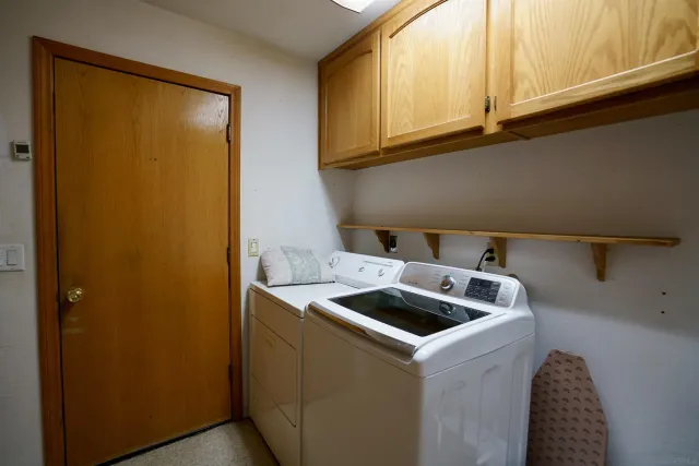 a kitchen with a sink a refrigerator and cabinets
