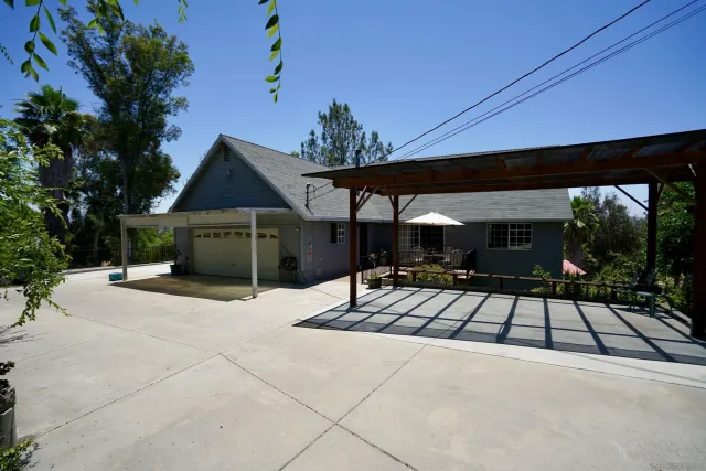 a view of a patio with table and chairs with wooden floor and fence