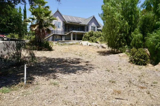 a front view of a house with a yard covered with snow