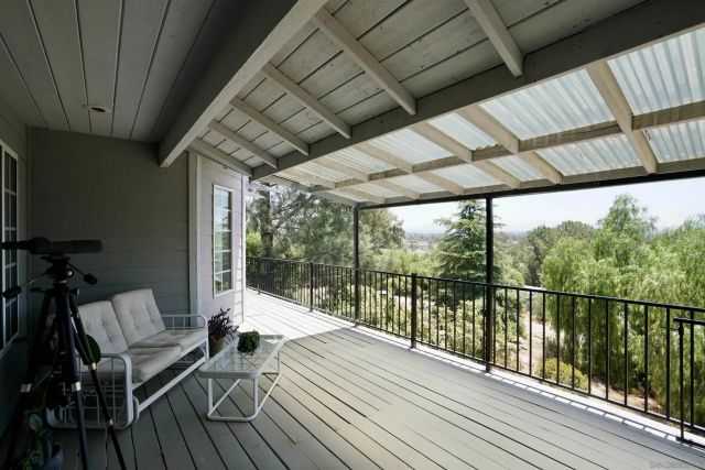 a balcony with wooden floor