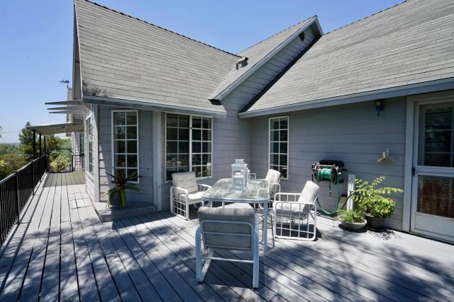 a view of a patio with table and chairs and potted plants