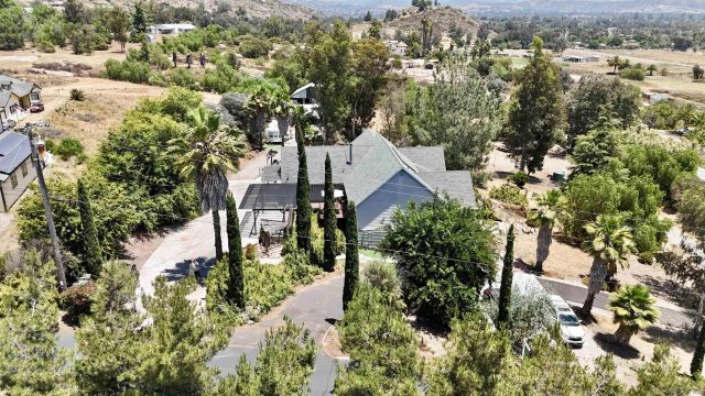 an aerial view of a house with a yard