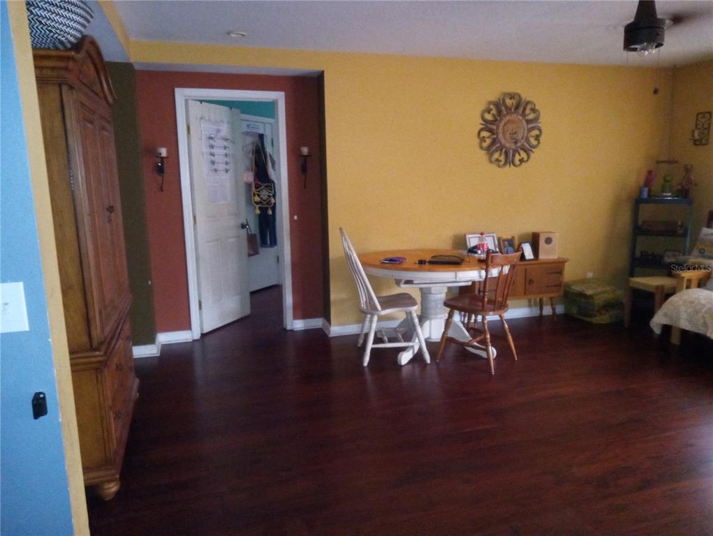 10933 Subtle Trail Drive Riverview, FL 33579 - Photo 4 of 22 a view of a dining room with furniture and wooden floor