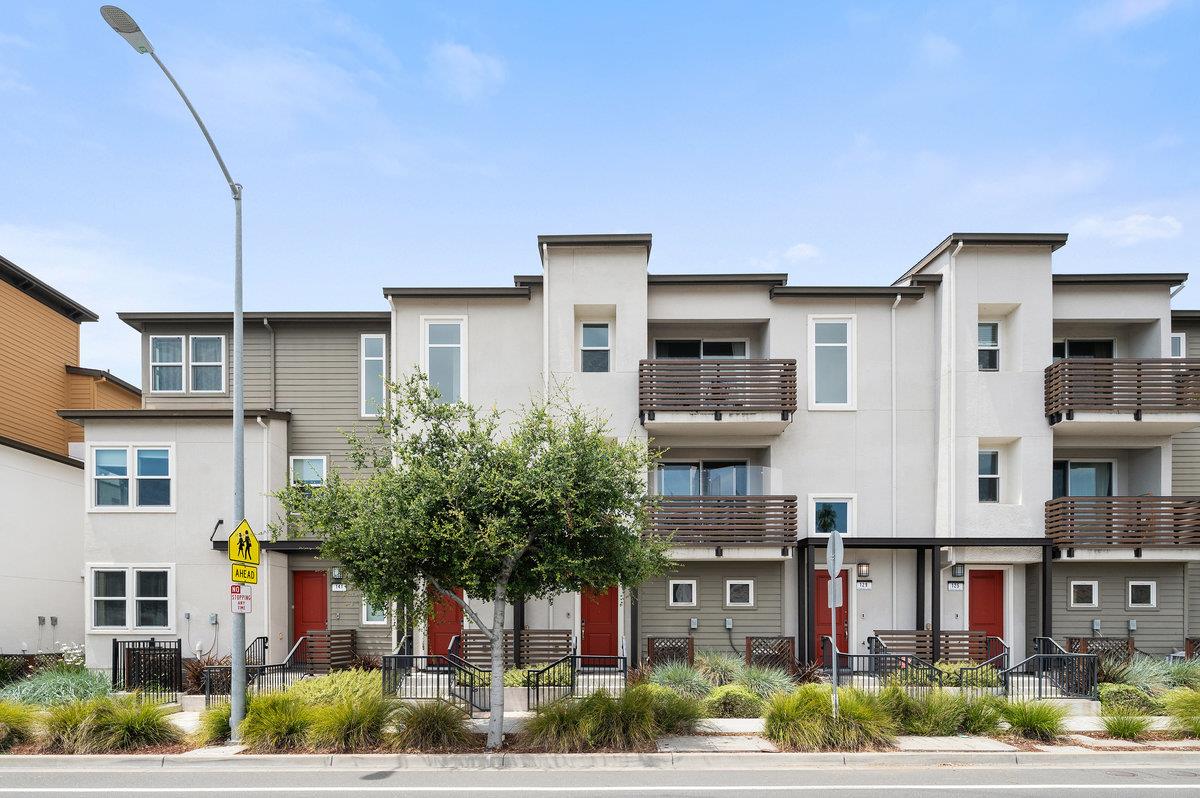 a front view of a residential apartment building with a yard