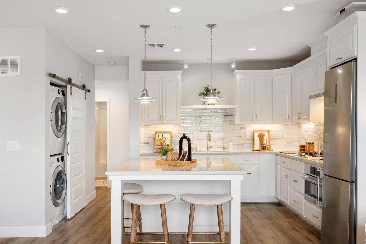 133 Stevenson Boulevard Fremont, CA 94539 - Photo 11 of 36 a kitchen with a sink a refrigerator and cabinets