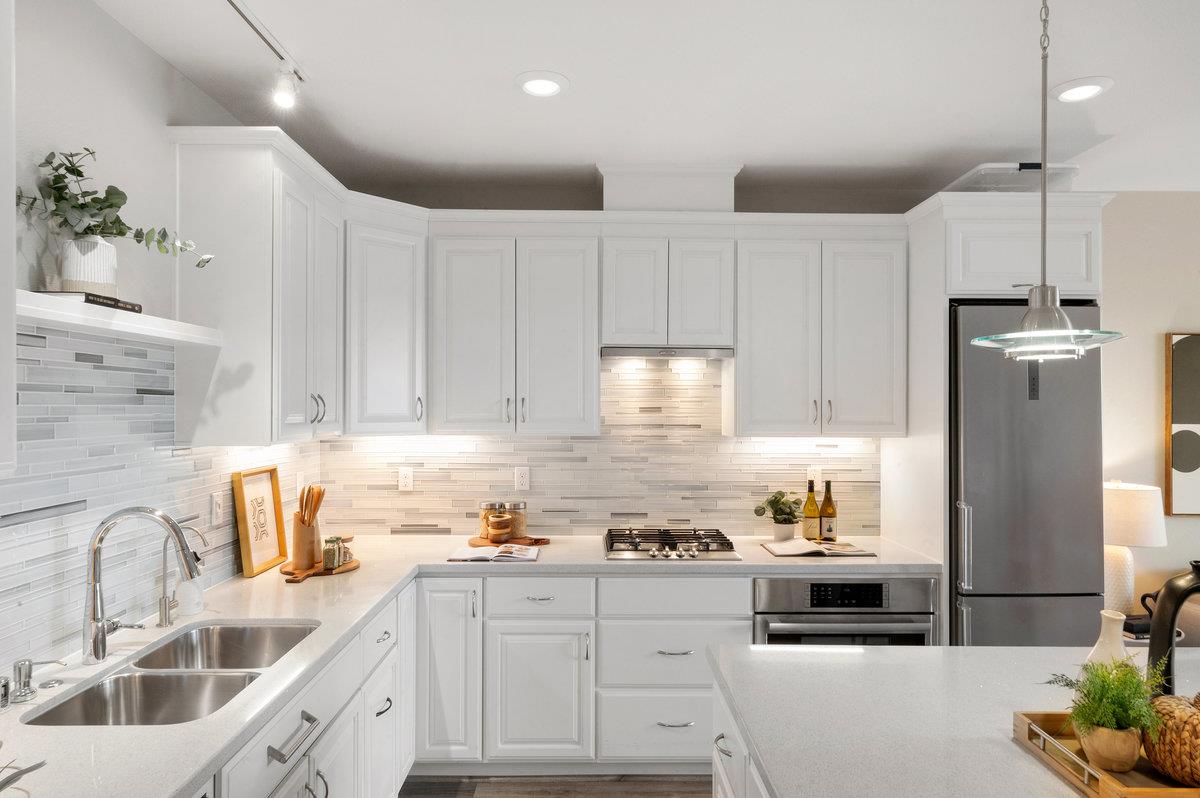 133 Stevenson Boulevard Fremont, CA 94539 - Photo 13 of 36 a kitchen with kitchen island granite countertop a sink stainless steel appliances and cabinets
