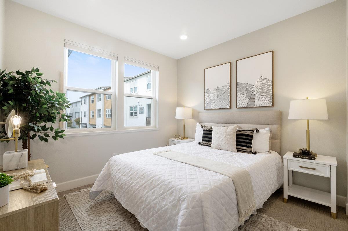 133 Stevenson Boulevard Fremont, CA 94539 - Photo 19 of 36 a bedroom with a large bed and a chandelier fan