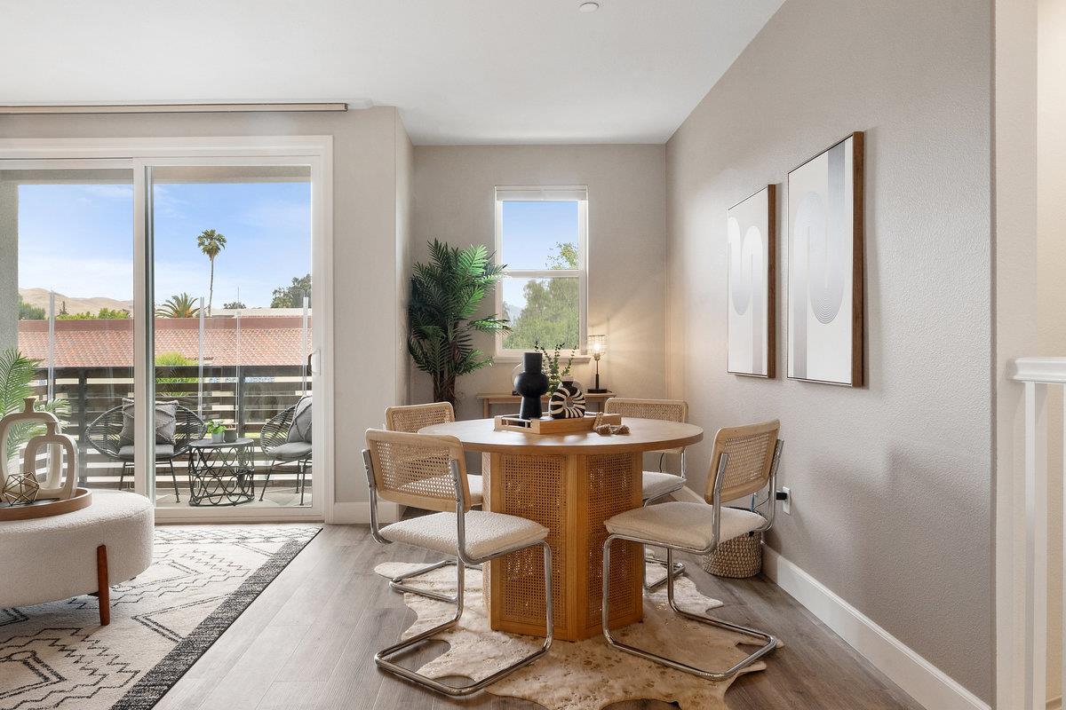 133 Stevenson Boulevard Fremont, CA 94539 - Photo 9 of 36 a living room with fireplace furniture and a floor to ceiling window