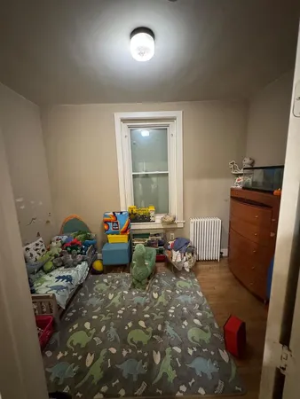 a bedroom with furniture and a window