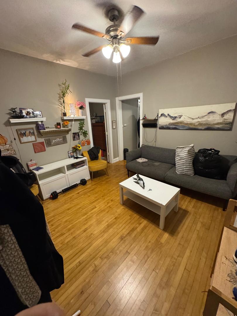 2344 South 58th Avenue, Unit 2 Cicero, IL 60804 - Photo 9 of 11 a living room with furniture and a chandelier