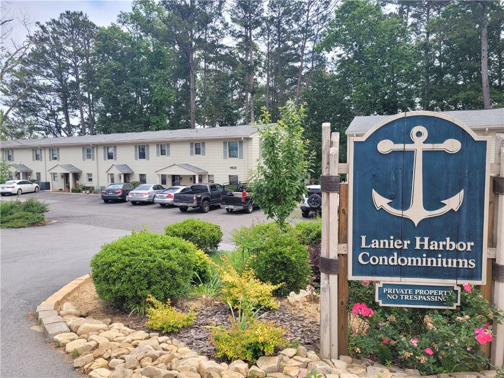 a view of sign board with flower plants