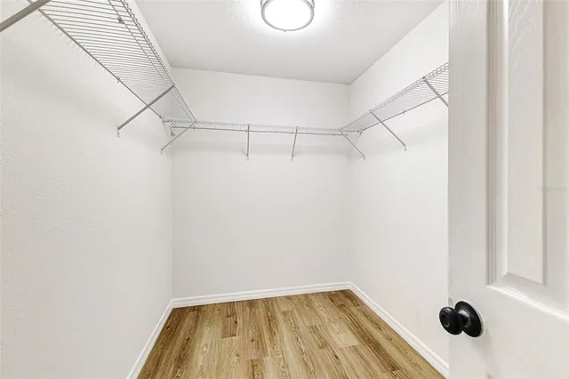 a view of a room with a walk in closet and a window