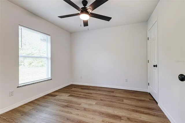wooden floor in an empty room with a window