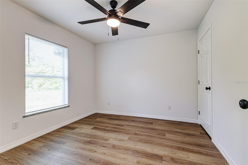 2728 Golfview Street Lakeland, FL 33801 - Photo 21 of 25 wooden floor in an empty room with a window