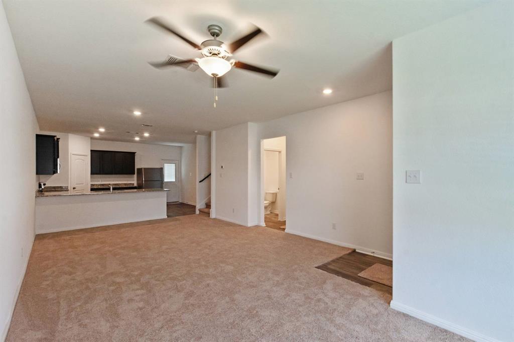 16429 Farmhouse Lane Elgin, TX 78621 - Photo 5 of 22 Spacious open-concept living area featuring plush carpeting, recessed lighting, and a ceiling fan