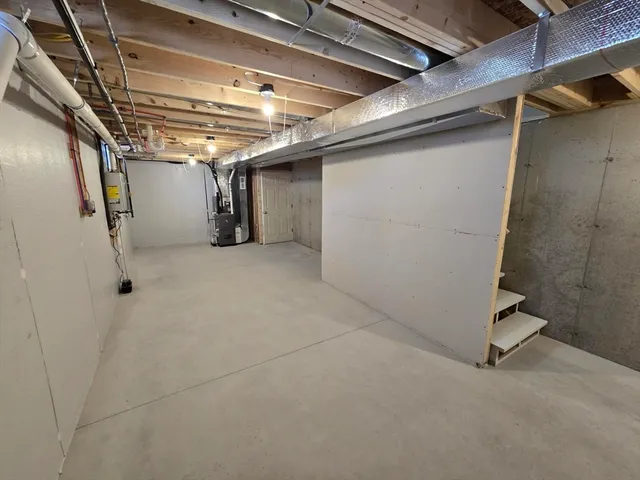 a kitchen with granite countertop a sink cabinets and stainless steel appliances