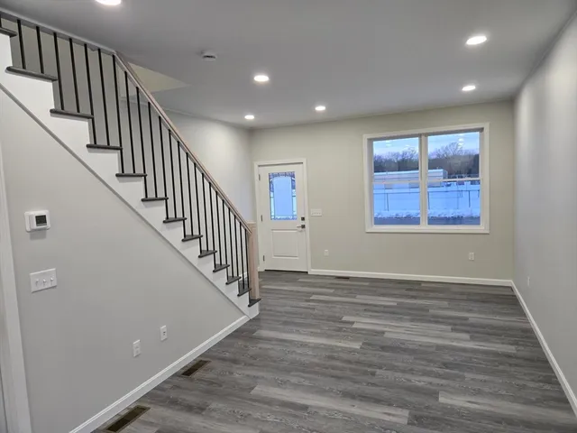 a view of an entryway with wooden floor