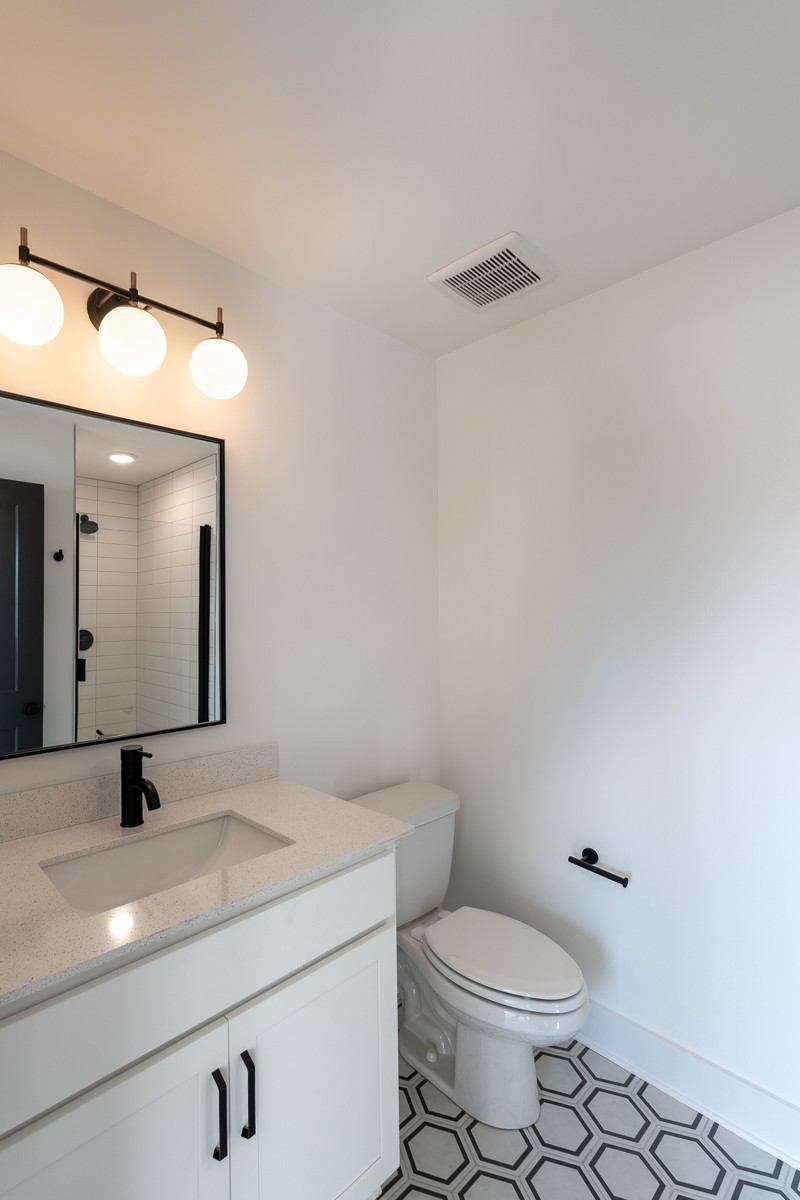 102 Duke Street, Unit 8 Nashville, TN 37207 - Photo 14 of 29 a bathroom with a granite countertop toilet sink and mirror