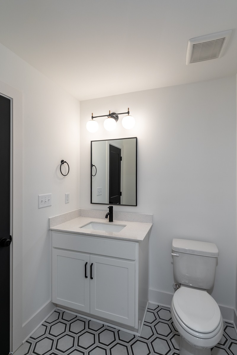 102 Duke Street, Unit 8 Nashville, TN 37207 - Photo 16 of 29 a bathroom with a toilet sink vanity and mirror