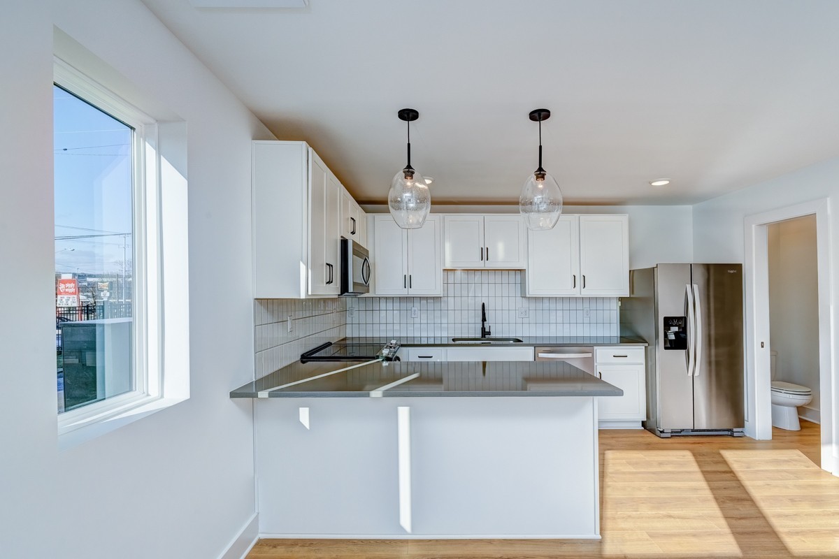 102 Duke Street, Unit 8 Nashville, TN 37207 - Photo 5 of 29 a kitchen with stainless steel appliances granite countertop a sink a stove a refrigerator and white cabinets
