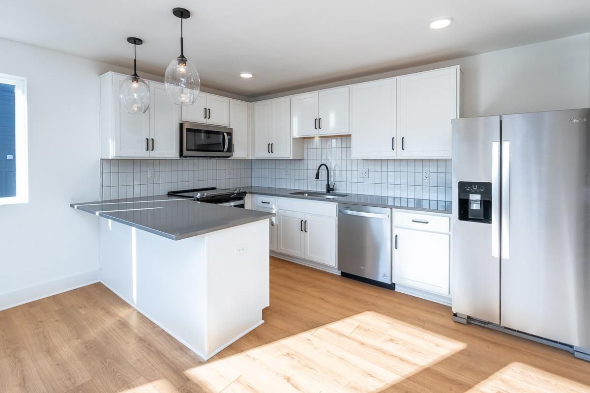 102 Duke Street, Unit 8 Nashville, TN 37207 - Photo 6 of 29 a kitchen with stainless steel appliances granite countertop a stove a sink and a refrigerator