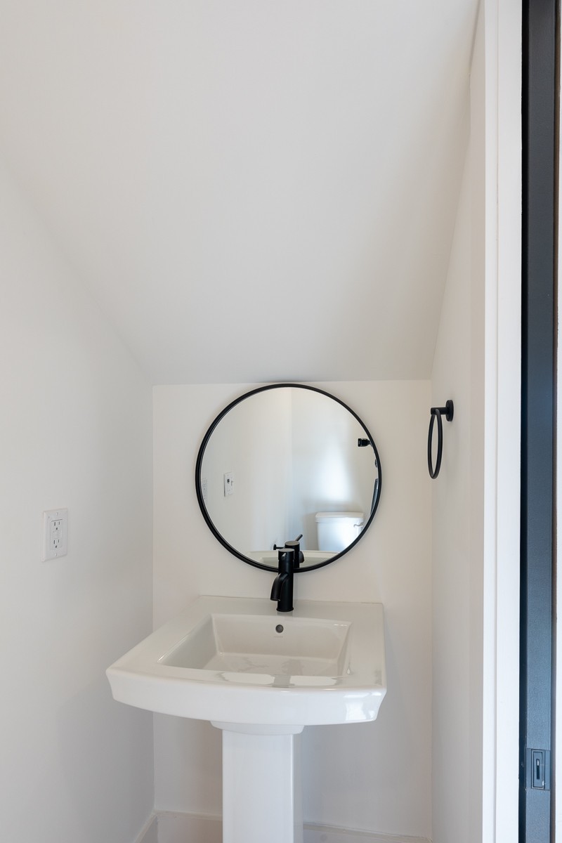 102 Duke Street, Unit 8 Nashville, TN 37207 - Photo 9 of 29 a bathroom with a sink and mirror