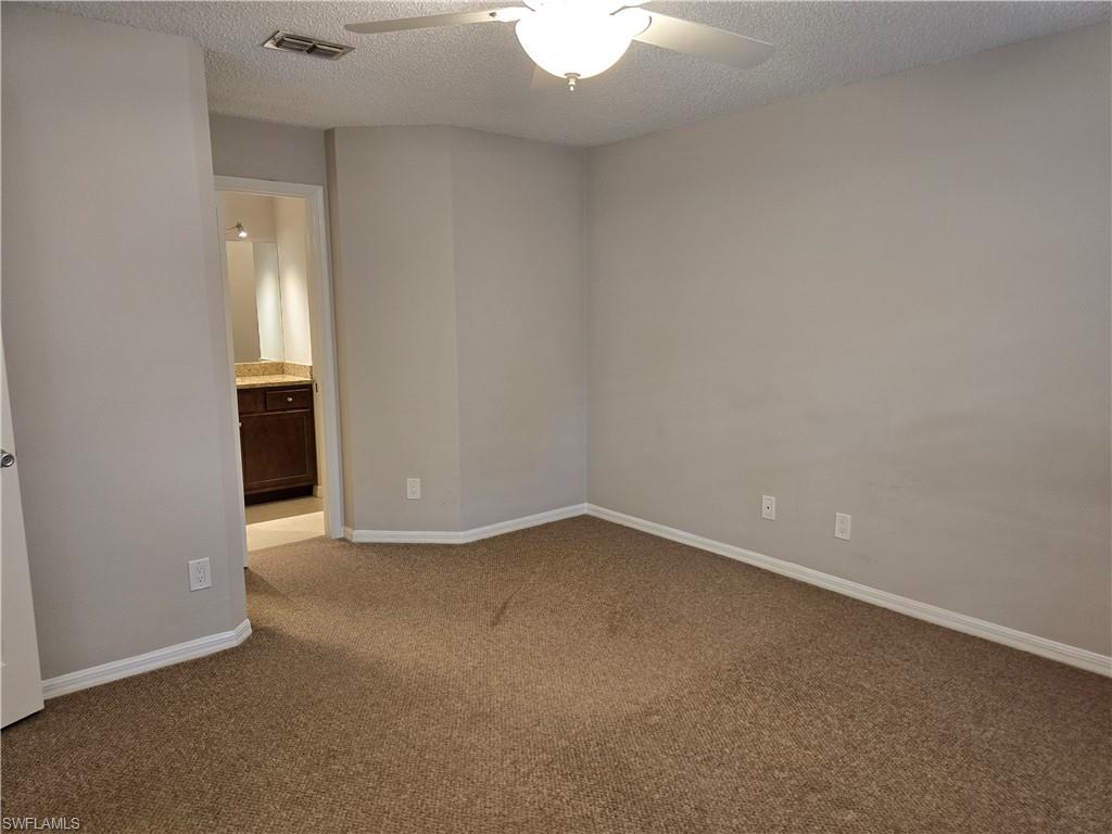 605 Squire Circle, Unit 203 Naples, FL 34104 - Photo 13 of 36 a view of an empty room with a window
