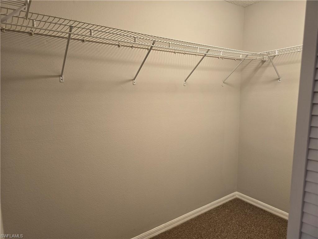 605 Squire Circle, Unit 203 Naples, FL 34104 - Photo 14 of 36 a view of a room with racks on the wall