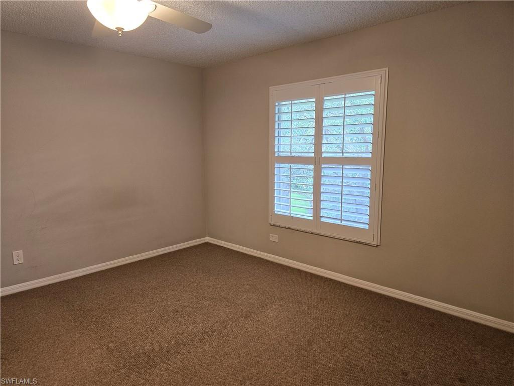 605 Squire Circle, Unit 203 Naples, FL 34104 - Photo 18 of 36 an empty room with a window