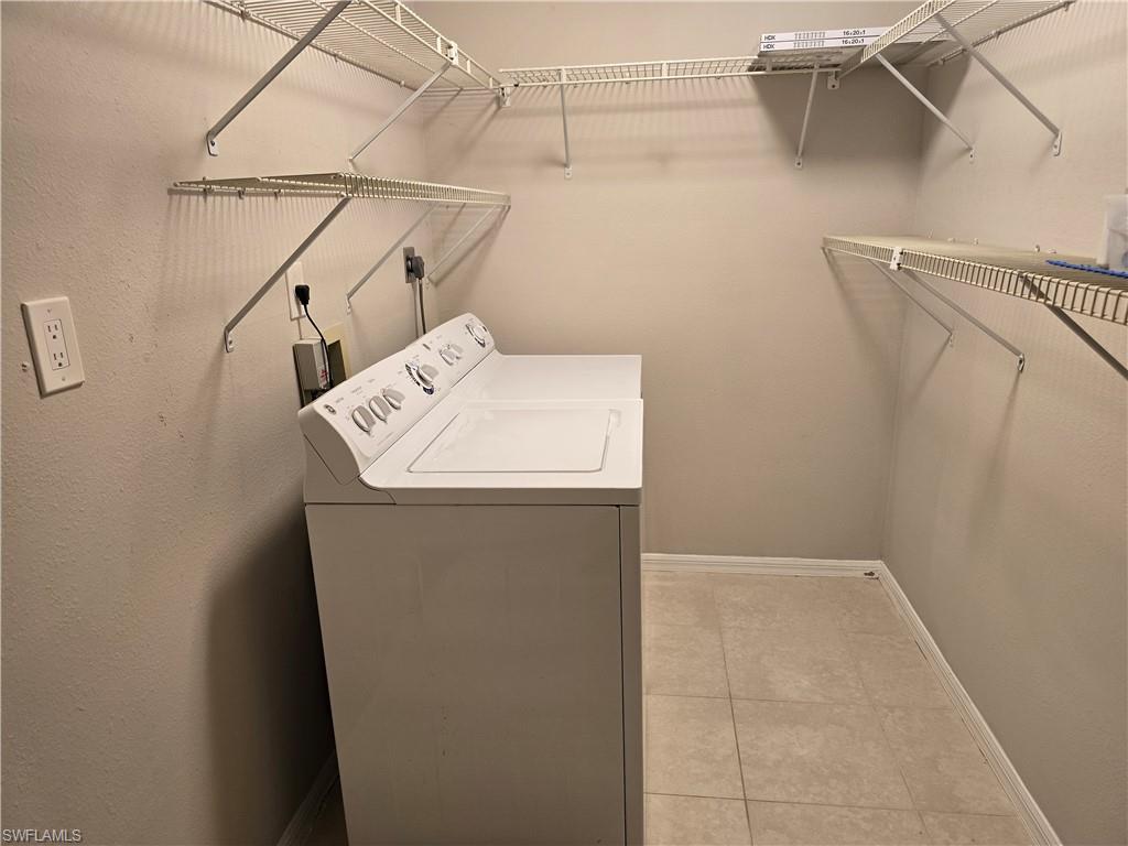 605 Squire Circle, Unit 203 Naples, FL 34104 - Photo 21 of 36 a utility room with dryer and washer