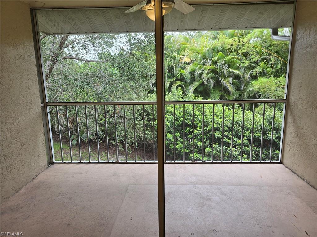 605 Squire Circle, Unit 203 Naples, FL 34104 - Photo 22 of 36 a view of a glass door and porch